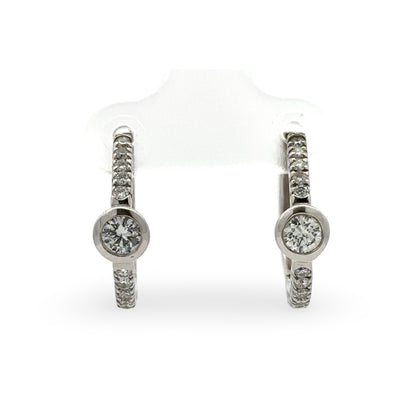 Pair of diamond hoop earrings on a white background