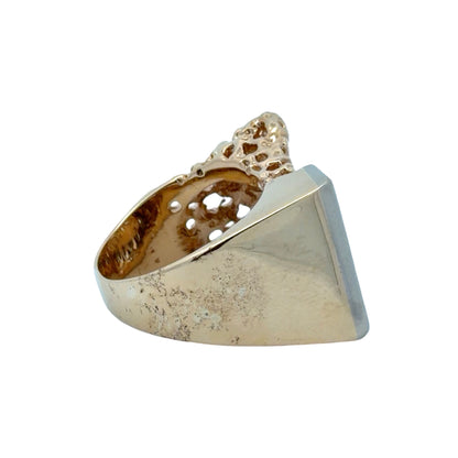 Side of nugget ring with tool marks and scratches on gold