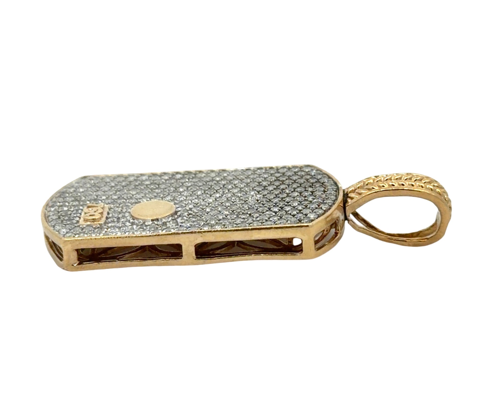 Side of gold pendant with small dent on the side