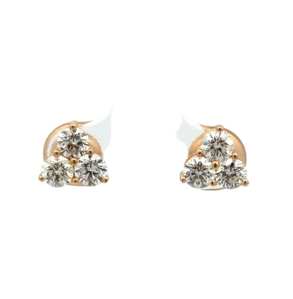 Pair of gold and diamond earrings on a white background