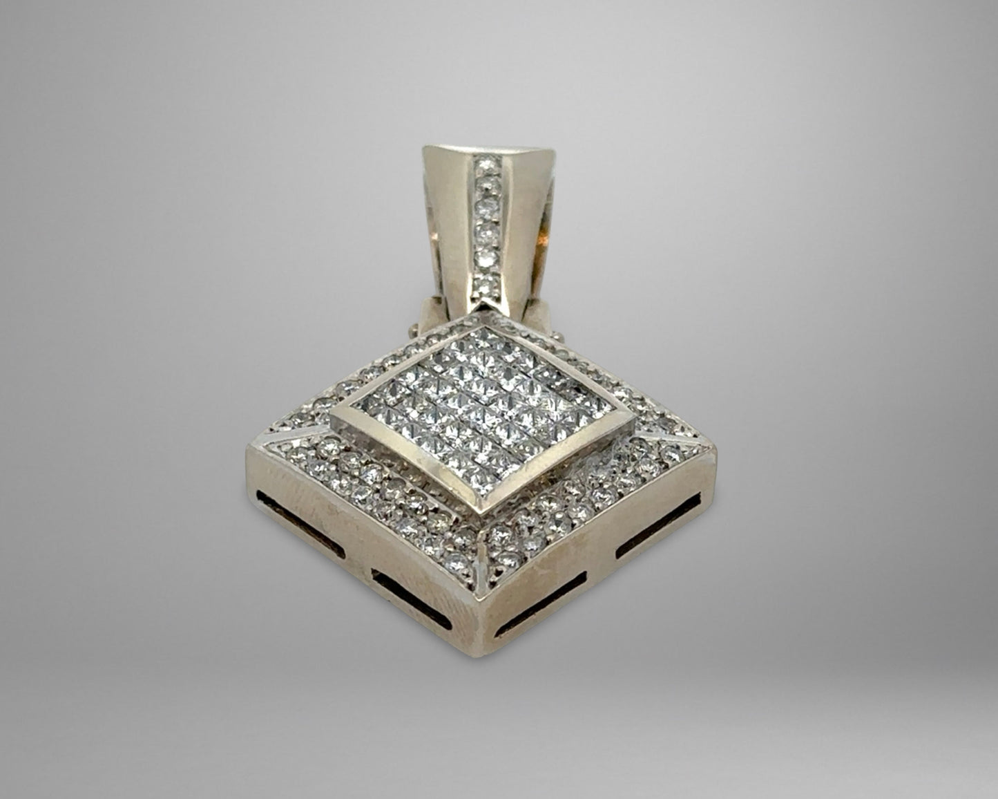 Diamond-encrusted pendant on a gray background