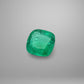 Cushion-shaped emerald on a gray background
