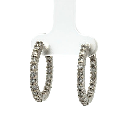 Pair of diamond hoop earrings on a white background