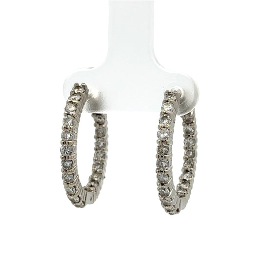 Pair of diamond hoop earrings on a white background