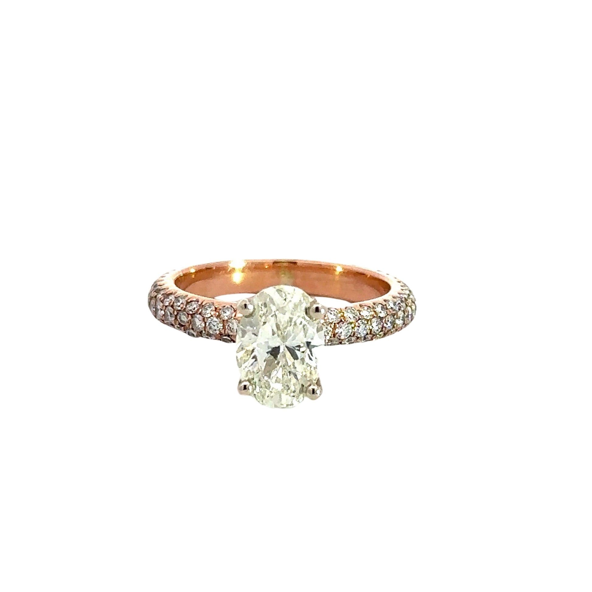 1.01 carat oval diamond as center stone with 3 rows of small round diamonds on the band on each side set in rose gold.