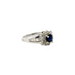Diagonal view of diamond and blue gemstone ring