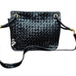 Black patent leather bag with misshaped shoulder strap