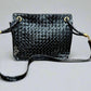 Black patent leather bag with misshaped shoulder strap