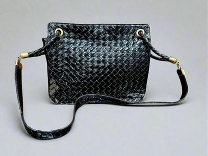 Black patent leather bag with misshaped shoulder strap