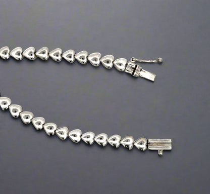 Front of clasp with white gold hearts and a safety lock