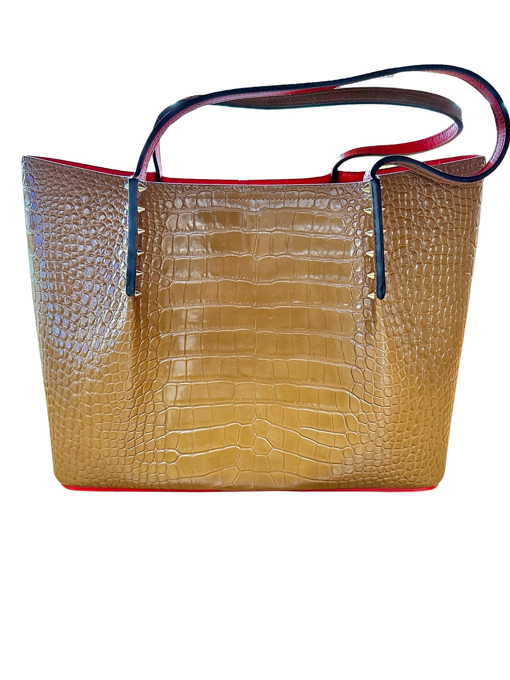 Front of brown tote bag with crocodile-like detailing and gold spike detailing. Shoulder straps are out of shape.