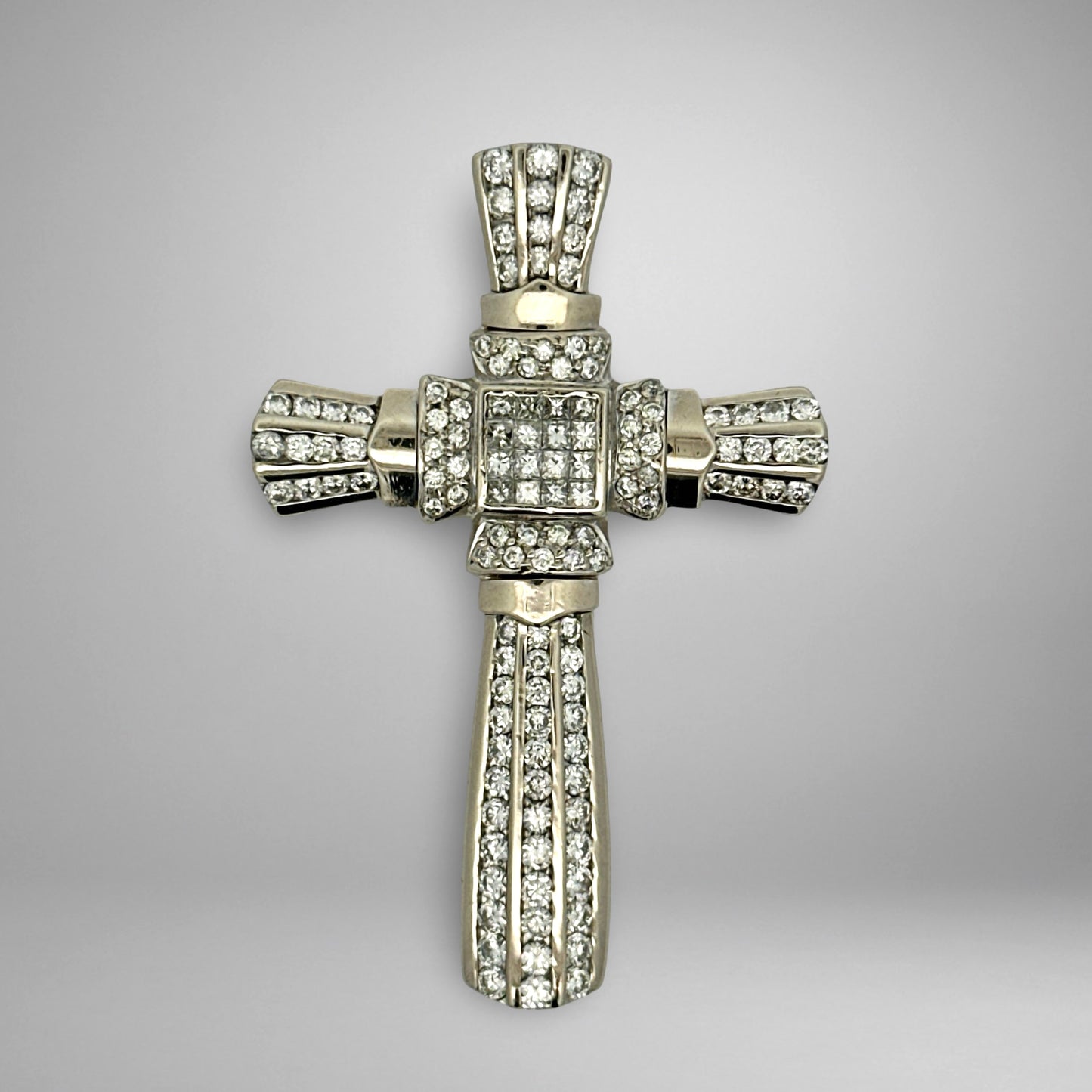 White gold diamond cross pendant with on a gray background