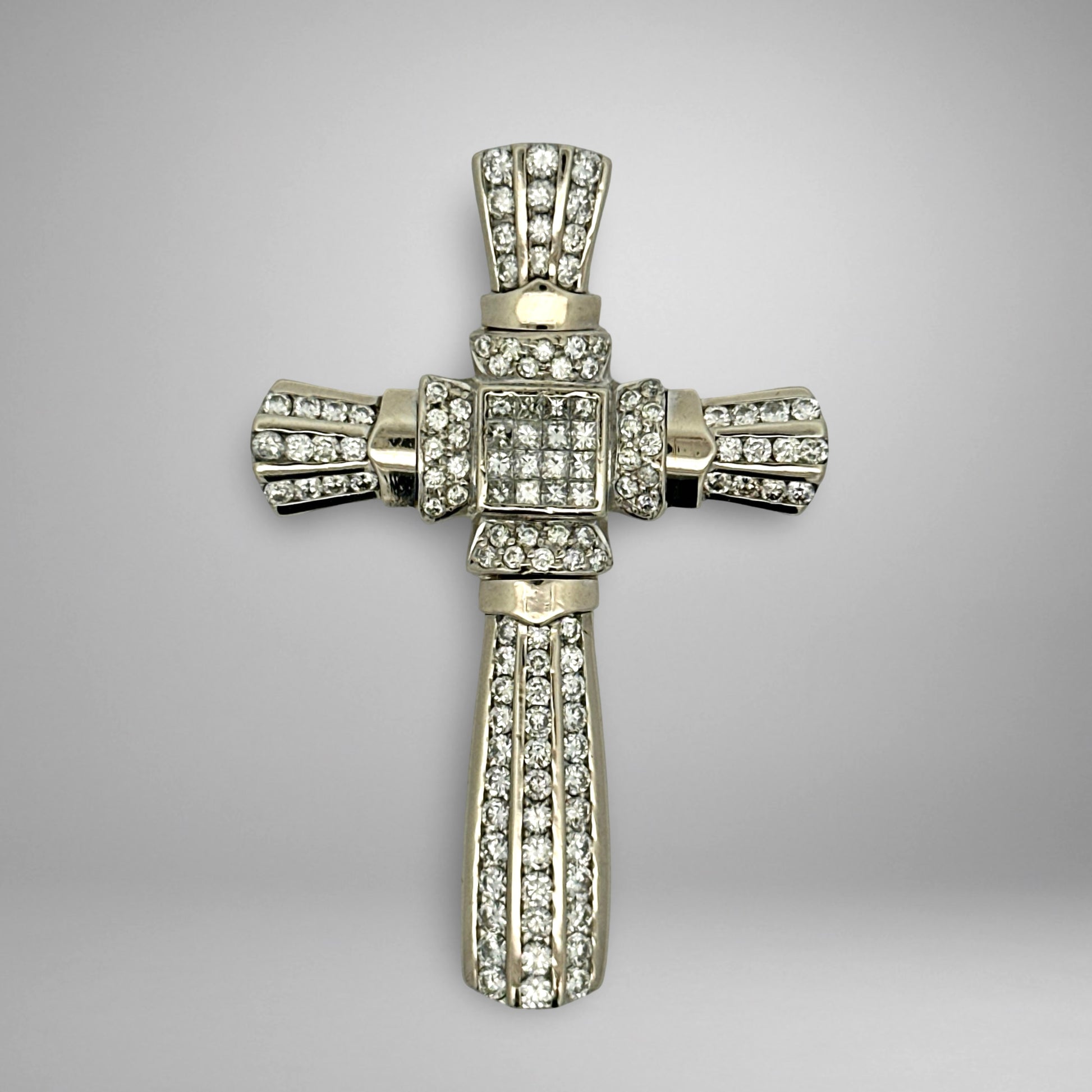 White gold diamond cross pendant with on a gray background