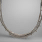 White gold necklace on a gray background