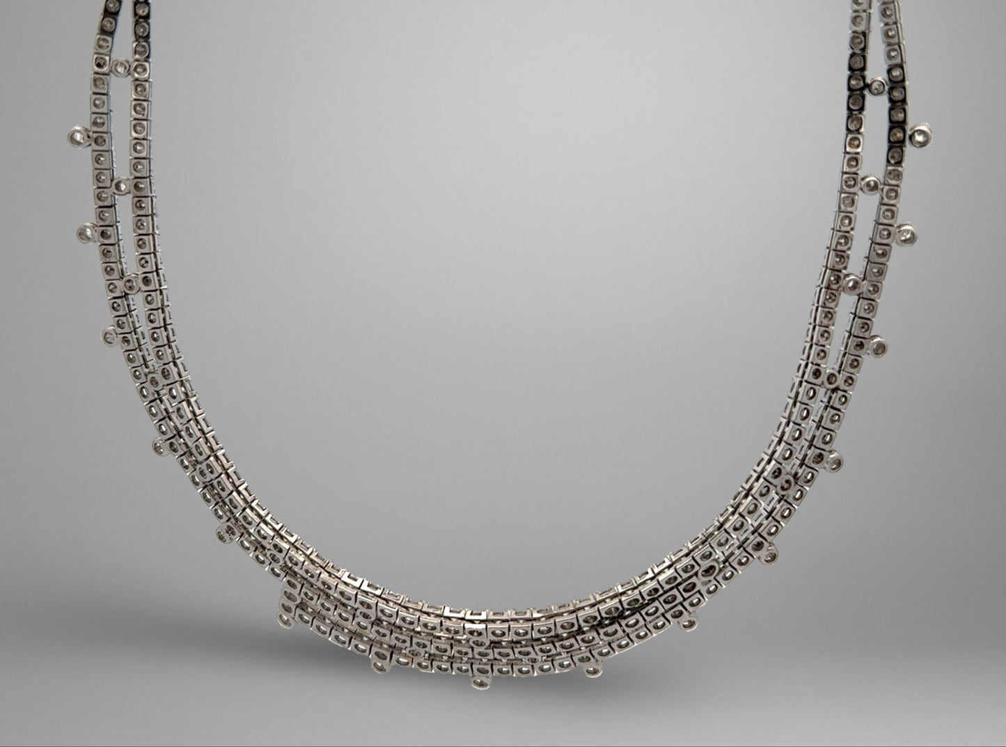 White gold necklace on a gray background