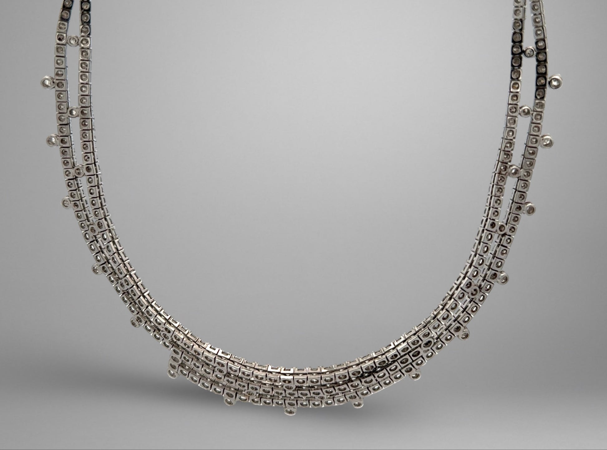 White gold necklace on a gray background