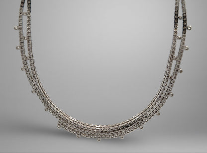 White gold necklace on a gray background