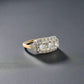 Diagonal view of white gold and yellow gold ring with 3 round diamonds