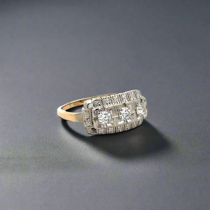Diagonal view of white gold and yellow gold ring with 3 round diamonds