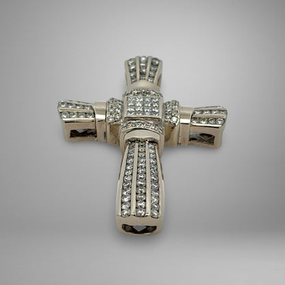White gold cross pendant with diamonds on a gray background