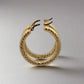 Side of yellow gold textured and polished hoops