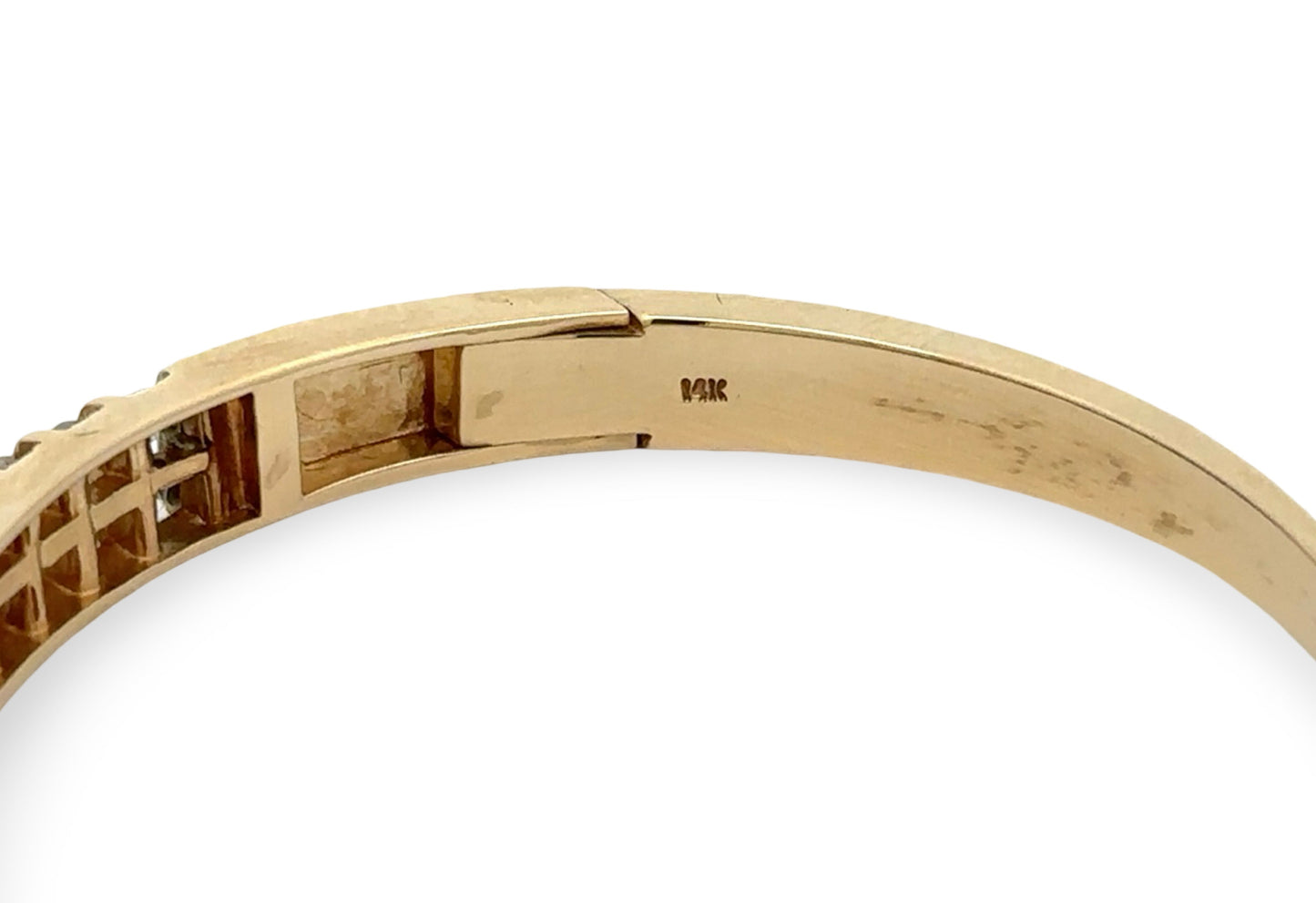 Gold bracelet with a close-up of the 14K stamp on a white background