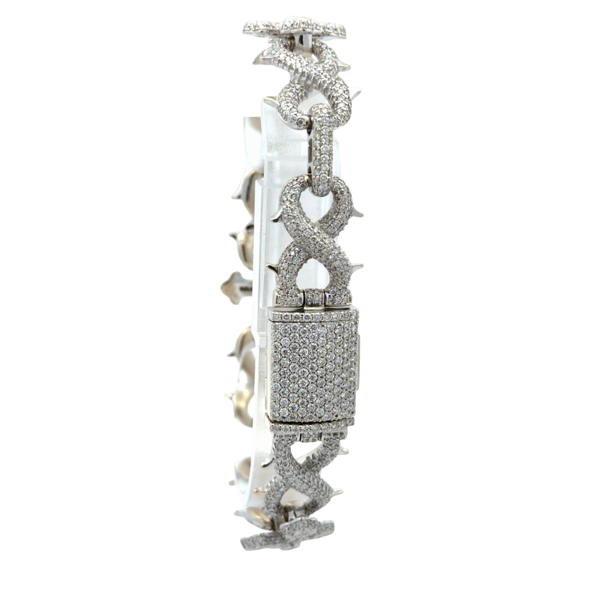Back of bracelet with box clasp covered in diamonds on a white background