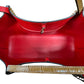 Red leather interior with gold clasp closure. 1 Interior side pocket