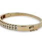 Gold bracelet with diamond accents on a white background