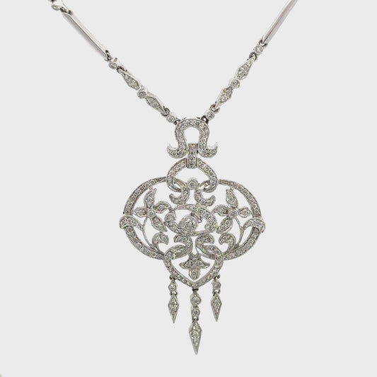 360 video of white gold diamond necklace with floral embellishments on pendant and diamonds on 2 of the links on the chain