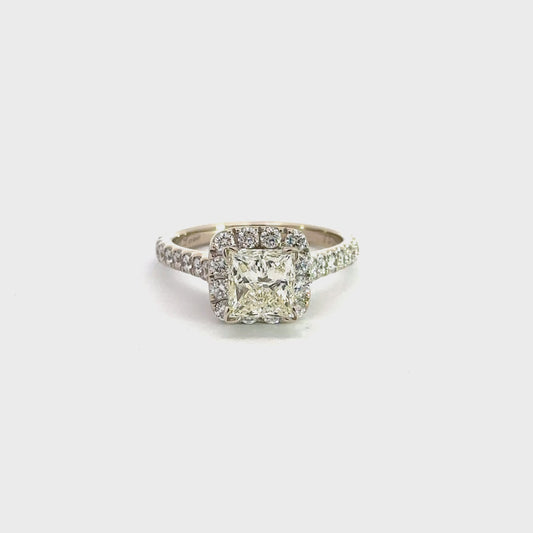 360 Video of white gold diamond ring with diamonds on half the band on each side, diamonds around the princess-cut center stone, and diamonds under the prongs called a hidden halo.