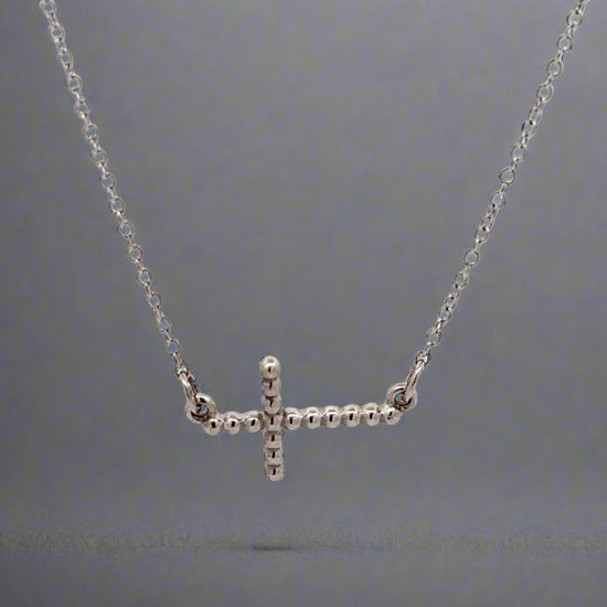 360 video of white gold cross necklace with beads