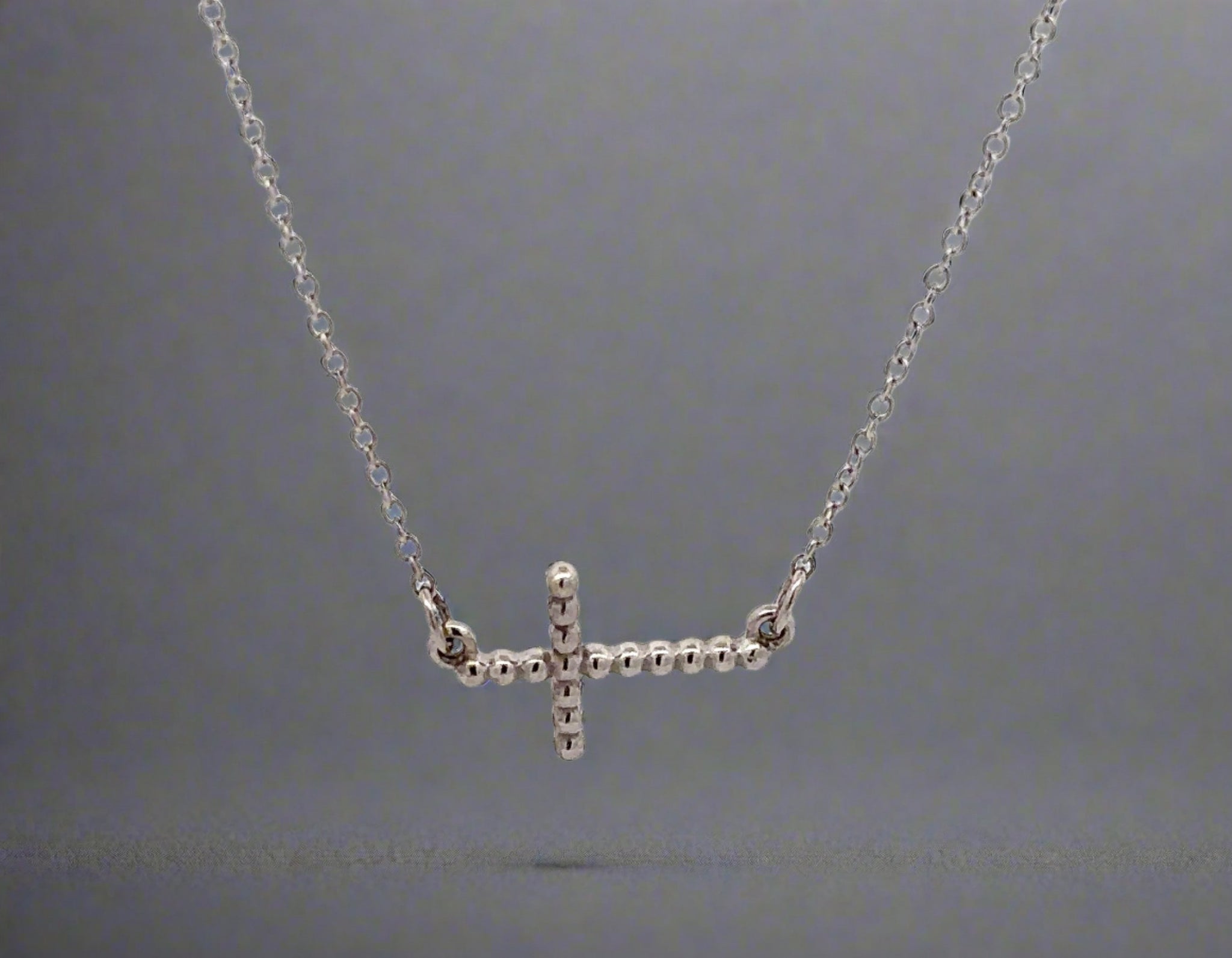 360 video of white gold cross necklace with beads