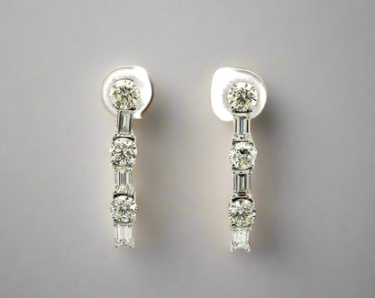 Video of white gold diamond drop earrings with 3 round diamonds alternating with 3 emerald cut diamonds