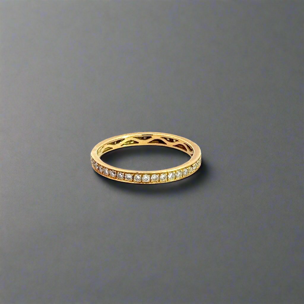 360 degree video of 18K yellow gold diamond band ring with small round diamonds all the way around the band