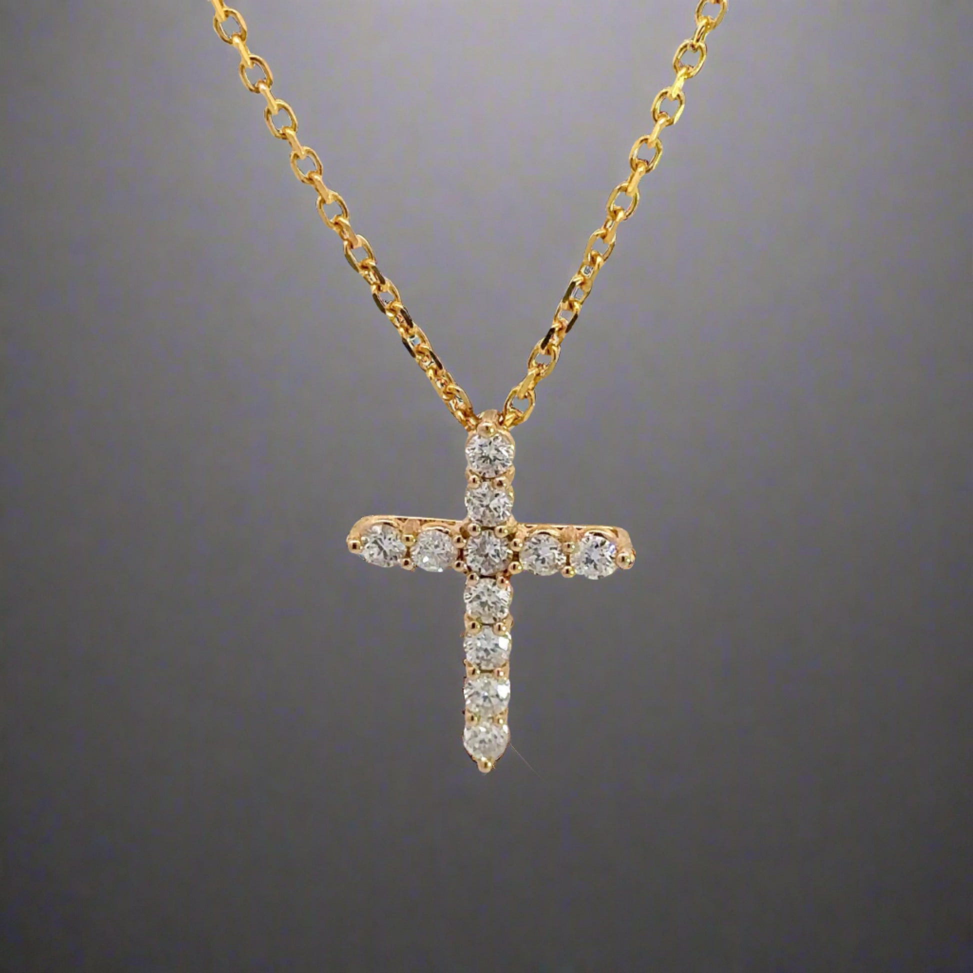 360 Video of Diamond Cross necklace with a thin yellow gold link chain and 11 round diamonds on cross.