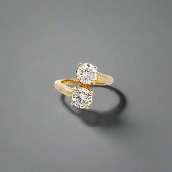 360 video of 2-stone diamond engagement ring in yellow gold with 2 round diamonds about .80 carats each. Scratches on gold.